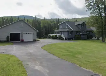 Exterior of a grey home with large garage